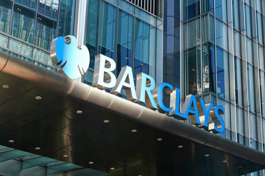 London, United Kingdom - February 03, 2019: Blue Barclays logo at their worldwide headquarters in Canary Wharf. It is British multinational investment bank, one of largest world banks.