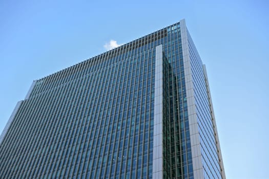 London, United Kingdom - February 03, 2019: Looking up glass and steel "10 Upper Bank Street" skyscraper at Canary Wharf. It's one of tallest buildings in UK capital, designed by Kohn Pendersen Fox