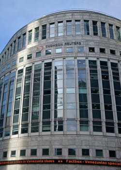 London, United Kingdom - February 03, 2019: Sun shines on Thomson Reuters offices building at Canary Wharf in UK capital. TR Group is Canadian multinational mass media and information firm