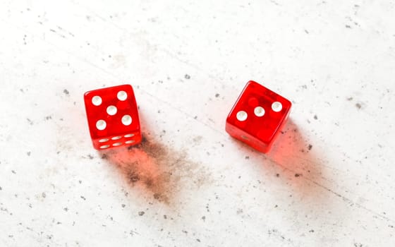 Two red craps dices showing Easy Eight (number 5 and 3) overhead shot on white board