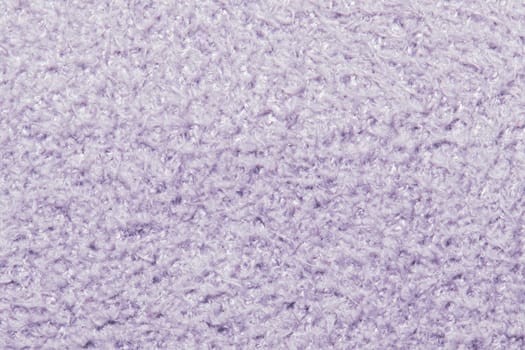 This image captures the detailed texture of a soft, lavender-colored fabric that appears plush and cozy.