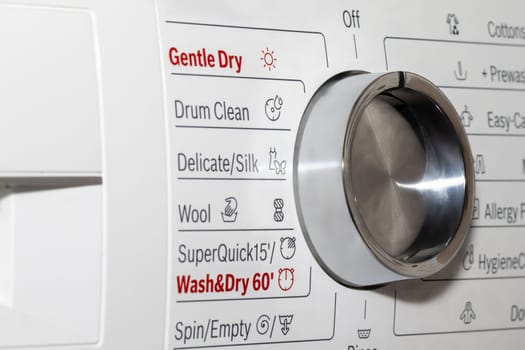 This image captures the detailed control panel of a modern washing machine, highlighting the settings for fabric care and cleaning cycles.