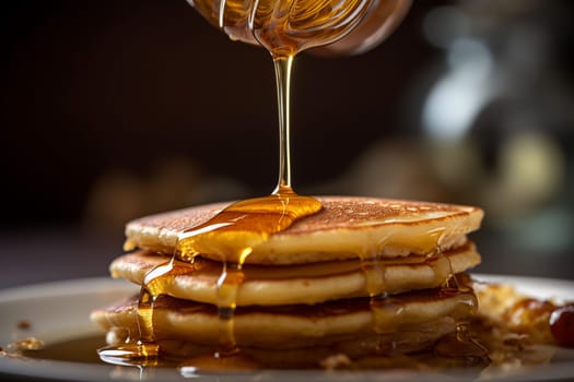Stack of pancakes drizzled with syrup on plate.