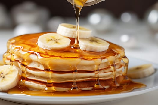 Stack of pancakes with maple syrup and banana slices on top.