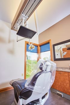 Modern and clean dental office interior with a view, showcasing a dentist chair and equipment in Fort Wayne, Indiana, 2017.