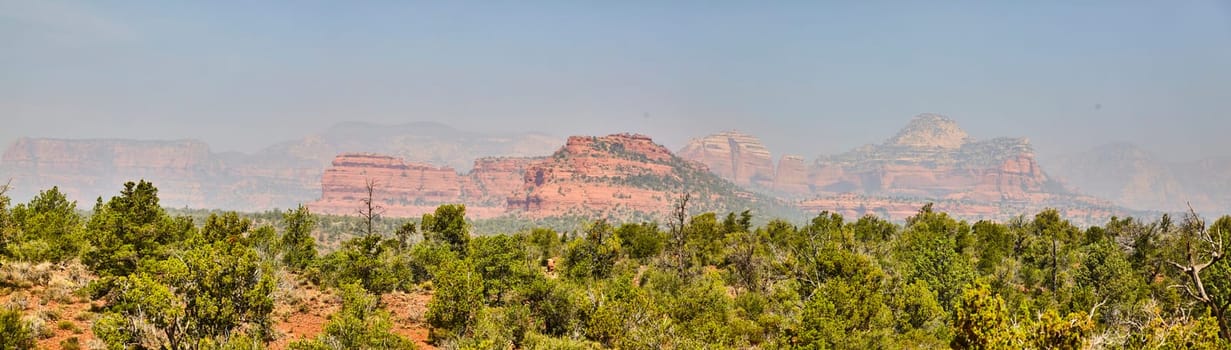 Panoramic view of serene desert beauty in Sedona, Arizona, 2016, highlighting red rock formations and vibrant desert flora