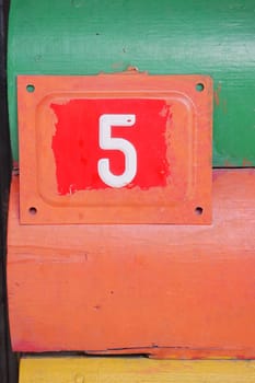 house number six. Decorative lettering on a brick wall