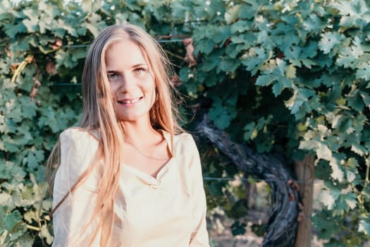 Woman at autumn winery. Portrait of happy woman holding glass of wine and enjoying in vineyard. Elegant young lady in hat toasting with wineglass smiling cheerfully enjoying her stay at vineyard