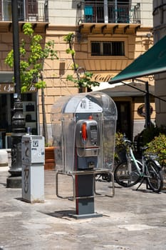 Palermo, Italy - July 20, 2023: A public pay phone in the historic city center.