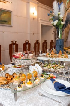 A beautifully set banquet table with an array of treats and a floral centerpiece, creating an elegant and luxurious ambiance, ideal for captivating food or travel blogs.
