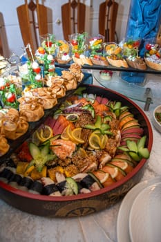 A selection of appetizers like sushi, bruschetta, and canapes arranged on a platter. Ideal for elegant gatherings or catering events. Isolated on a white background.