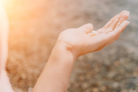 Woman eating milky almond nuts. A young caucasian woman choping fresh green almond after morning fitness yoga near sea. Only hands are visibly. Healthy vegan food. Slow motion. Close up