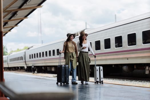 Woman traveler tourist walking with luggage at train station. Active and travel lifestyle concept.