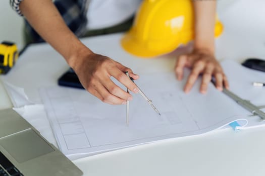 Architect sketching a construction project working on project in modern office.