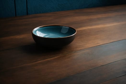 A blue bowl sits prominently on top of a wooden table, creating a simple yet striking image.