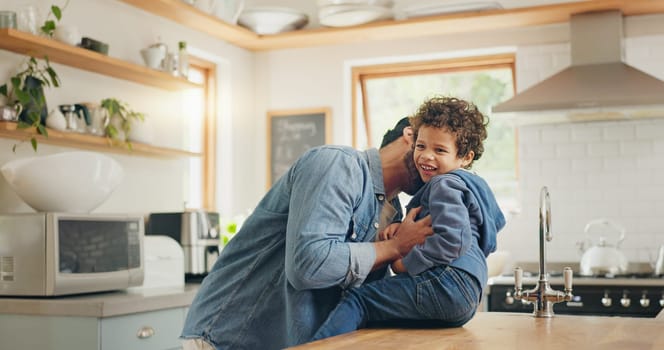 High five, dad and kid playing in the kitchen or happy moment, memory or quality time together in family home or house. Bonding, game and father being silly, funny or crazy with son, boy or children.