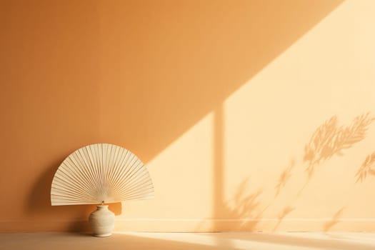Eastern interior. Open fan near an empty wall with shadows.