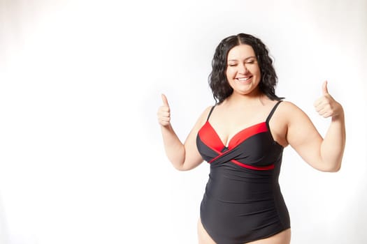 Happy attractive thick woman in swimsuit posing on white background. Body positive, photoshoot, selfie. Funny plus size model, Winner in Weight loss
