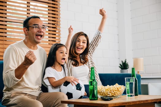 A family of fans enjoys watching a football match at home, creating an atmosphere of togetherness and bonding. Their cheers and smiles reflect the joy of the game and shared happiness.