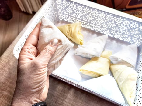 Plastic bag folded into triangle for storage. Ways of storing and laying at home