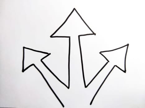 Three diverging Hand drawn black marker arrows. Concept of business, choosing direction, moving forward. Abstract sign, background, texture. Blurred