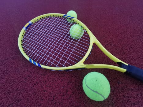 yellow tennis balls and two racquet on hard tennis court surface, top view tennis scene. High quality photo