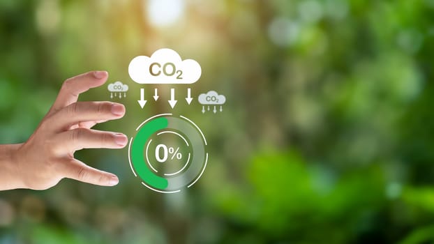 Hand holding CO2 reducing icon for decrease carbon dioxide emission, Business and environment sustainable, industry and company Reduce of carbon emissions to Net zero greenhouse gas target.