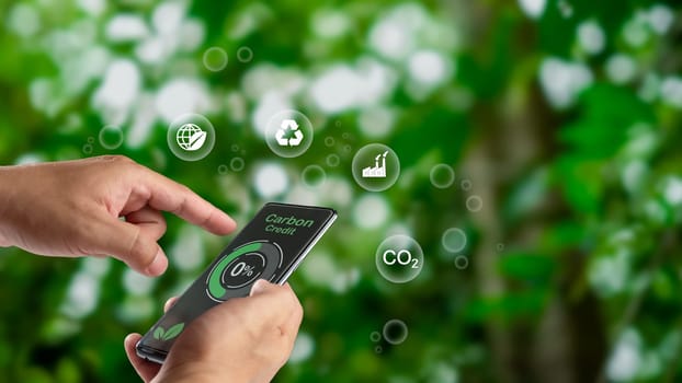 Human using a smartphone to trade carbon credit on application, carbon credit concept, carbon etf to invest in sustainable business, green climate funds investment, Net zero emission, Clean technology