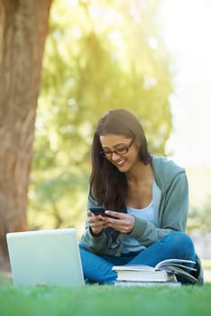 Woman, garden and laptop with books, glasses and cellphone for study, learning and college. Latino student, park and technology for research, communication and university for online education.