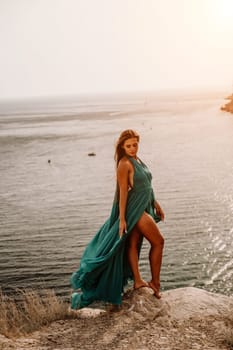 Woman sea trevel green dress. Side view a happy woman with long hair in a long mint dress posing on a beach with calm sea bokeh lights on sunny day. Girl on the nature on blue sky background