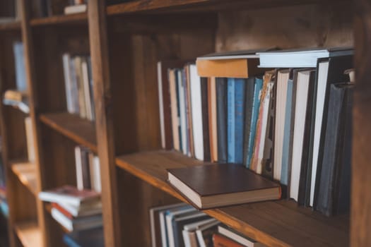 Single Book Resting On Bookshelf In Library, Highlighting The Intricate Details Of Its Cover And Spine. Literature And Education, Showcasing Organized Arrangement Of Books Within Library. Close-Up Shot. High quality photo