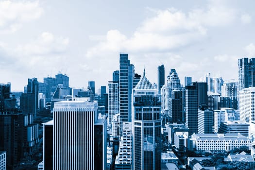 Closeup image of Bangkok cityscape. Modern skyscrapers with monochrome blue filter. Modern architectural building skyline with blue sky. Side view. Business background. Day light. Ornamented.