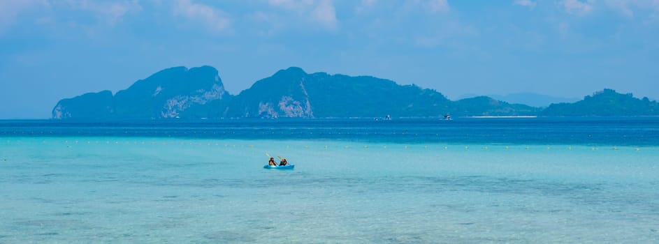 Koh Kradan is a tropical island with palm trees soft white sand, and a turqouse colored ocean in Koh Kradan Trang Thailand