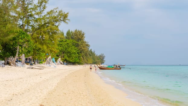 Koh Kradan a tropical island with palm trees soft white sand, and a turqouse colored ocean in Koh Kradan Trang Thailand