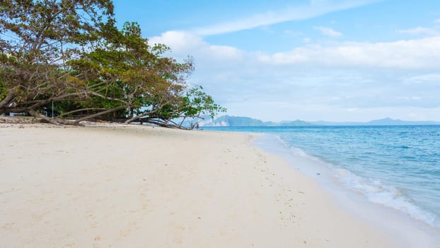 Koh Kradan a tropical island with palm trees soft white sand, and a turqouse colored ocean in Koh Kradan Trang Thailand