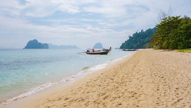 Drone aerial view at Koh Ngai island with palm trees soft white sand, and a turqouse colored ocean in Koh Ngai Trang Thailand