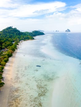 Drone top aerial view at Koh Kradan a tropical island with palm trees soft white sand, and a turqouse colored ocean in Koh Kradan Trang Thailand