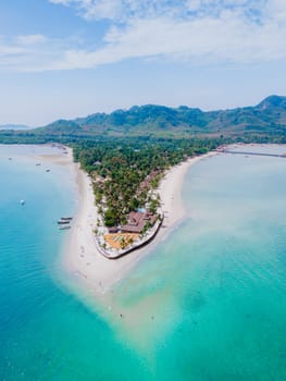 Top view at Koh Muk a tropical island with palm trees and soft white sand, and a turqouse colored ocean in Koh Mook Trang Thailand