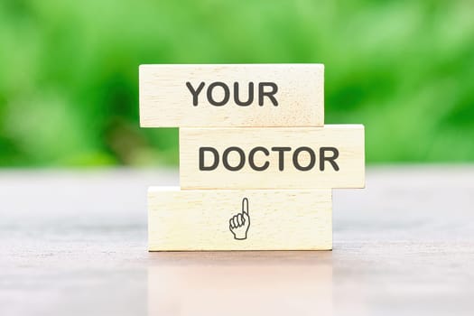 YOUR DOCTOR Back to school the inscription on wooden bars against a background of green plants is out of focus