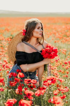 Woman poppies field. portrait of a happy woman with long hair in a poppy field and enjoying the beauty of nature in a warm summer day