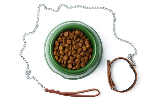 Green plastic bowl with dry pet food isolated on white background