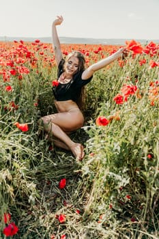 Woman poppies field. portrait of a happy woman with long hair in a poppy field and enjoying the beauty of nature in a warm summer day