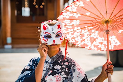 Asian girl in kimono and umbrella in Japanese theme park Hinoki Land in Chai Prakan District, Chiang Mai