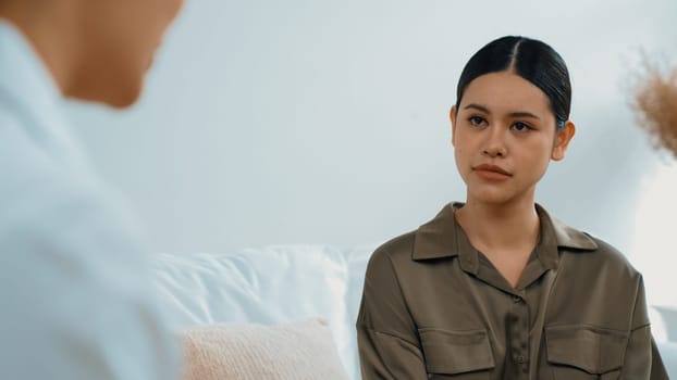 Sad PTSD woman patient in therapy for mental health with psychologist, depression or grief after life failure. Frustrated trauma young woman talking to vivancy psychologist about emotion in clinic