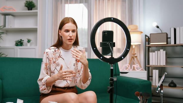 Woman influencer shoot live streaming vlog video review makeup prim social media or blog. Happy young girl with cosmetics studio lighting for marketing recording session broadcasting online.