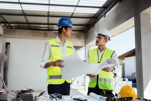 team engineer, foreman, architect meeting for colleagues discussing and checks construction blueprints at onsite.