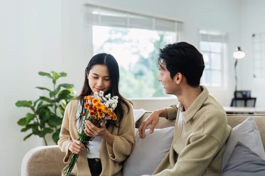 Young couple Hug and giving flower on Valentine's Day. Romantic day together. Valentine's Day concept.