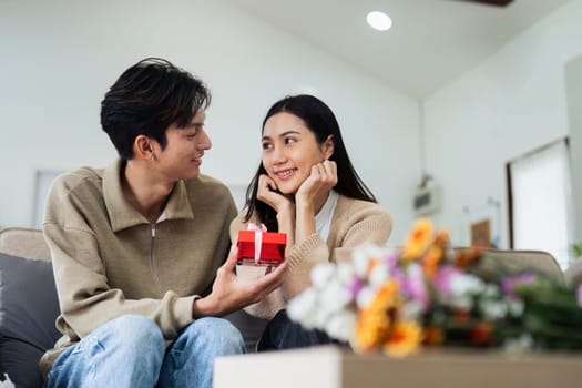 Young couple Hug and giving present on Valentine's Day. Romantic day together. Valentine's Day concept.