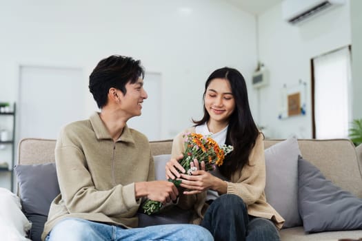 Young couple Hug and giving flower on Valentine's Day. Romantic day together. Valentine's Day concept.