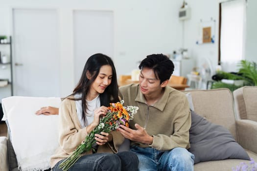 Young couple Hug and giving flower on Valentine's Day. Romantic day together. Valentine's Day concept.